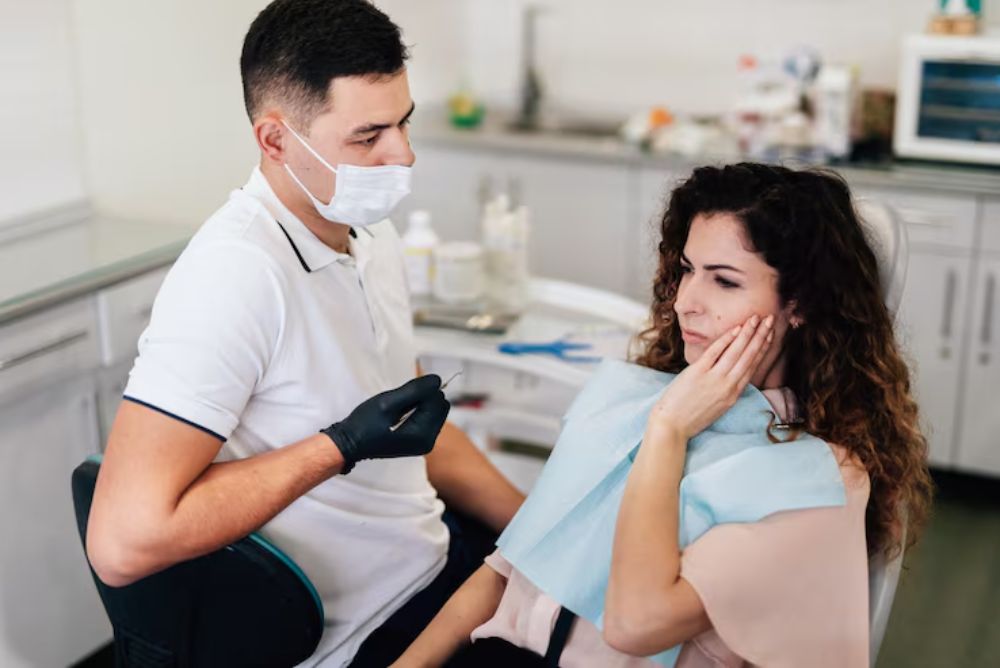 patient experiencing tooth sensitivity after losing a dental filling